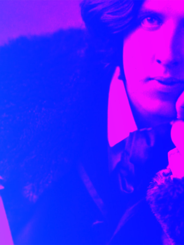 Colourful graphic featuring a photograph of Oscar Wilde